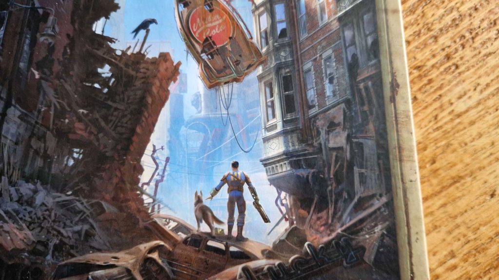 The cover of a book on a wooden surface showing a Vault-dweller wandering through a ruined downtown area accompanied by a dog