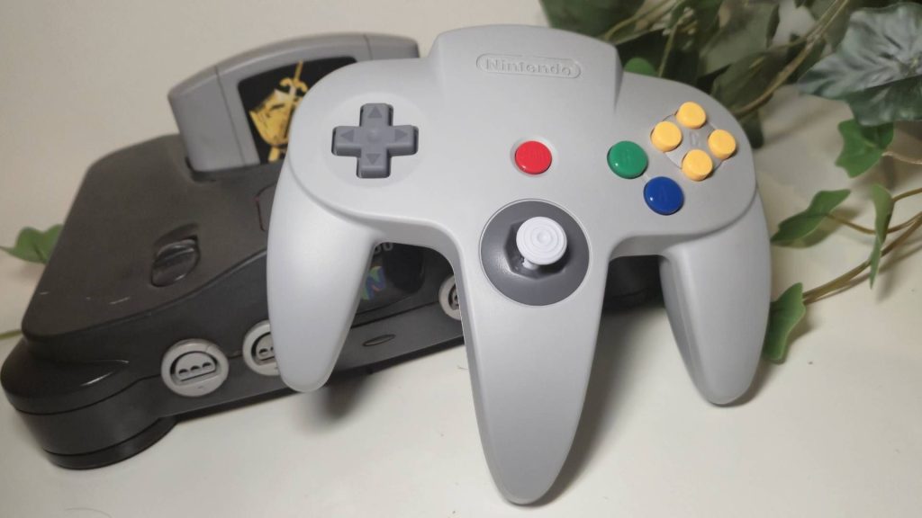 Photo of the Switch N64 controller sitting on a real N64 console.