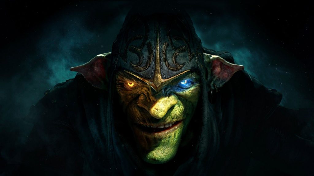 A close-up of Styx looking up from under his hood in darkness, one eye glowing amber, and the other light blue