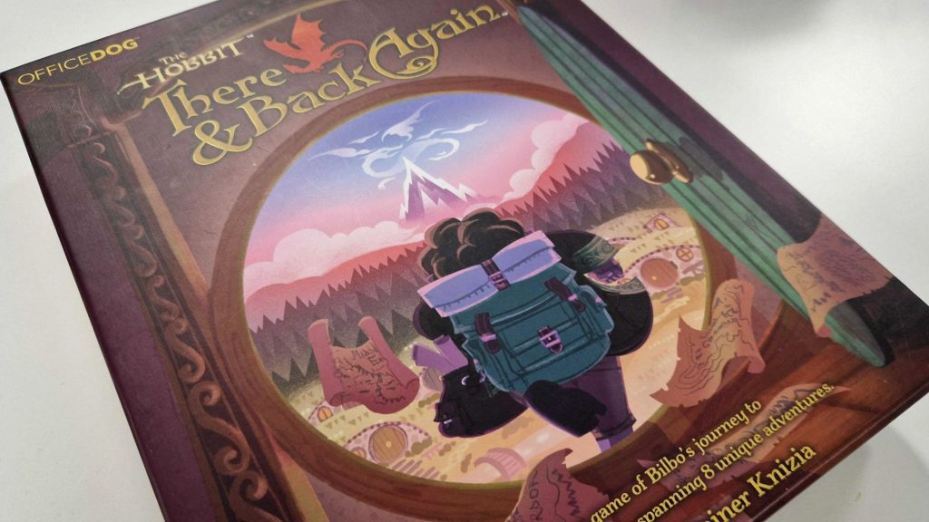 The Hobbit: There &amp; Back Again box, which shows Bilbo Baggins from behind striding out of his front door, on a white surface