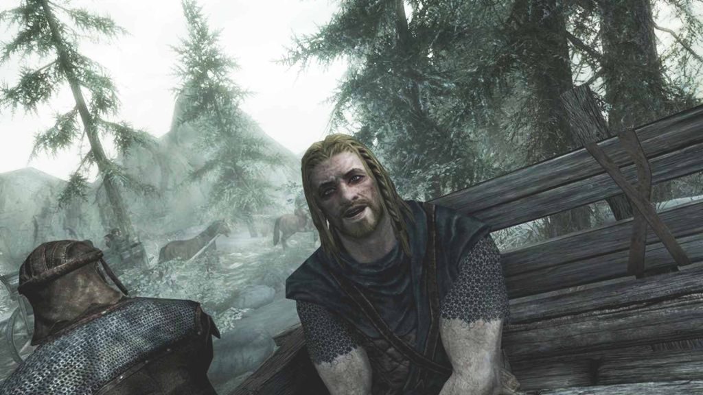 Ralof sitting in a prisoner wagon chatting to the Dragonborn during the opening of Skyrim.