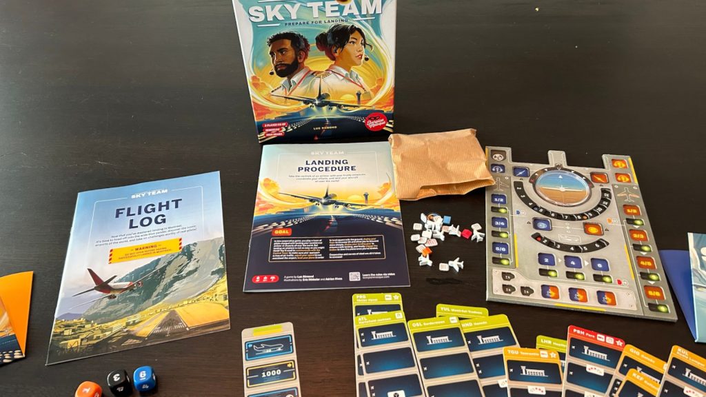 The Sky Team box, board, instruction booklets, and components on a wooden table
