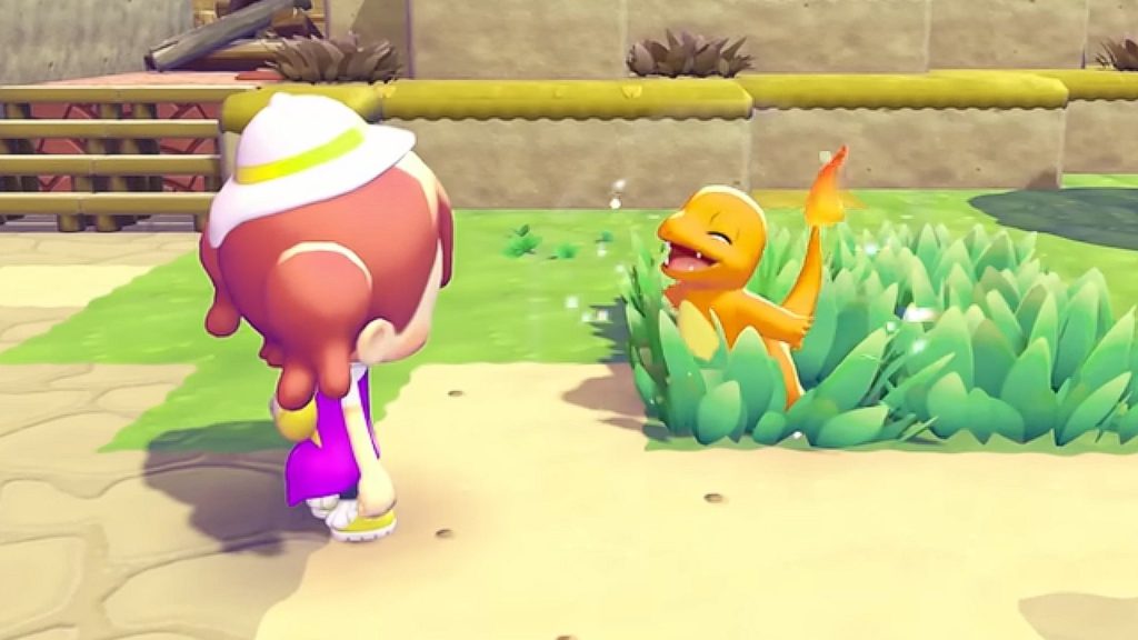 A Charmander pops out of the grass as the player searches for shiny Pokemon in Pokopia.