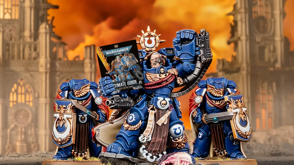 Marneus Calgar miniature holding the Warhammer 40,000 The Ultimate Guide book