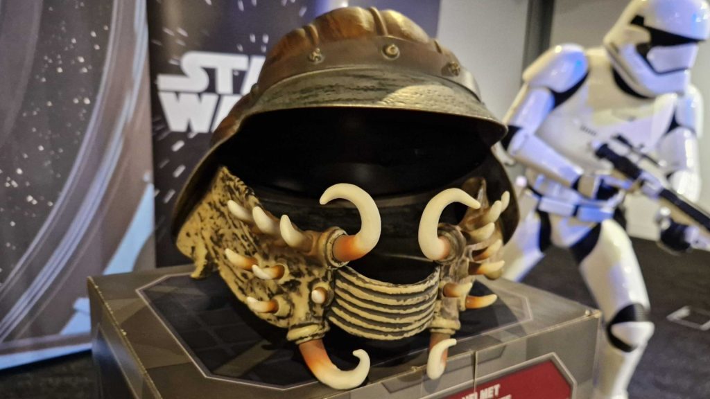Lando helmet replica from Star Wars, beside a Stormtrooper suit