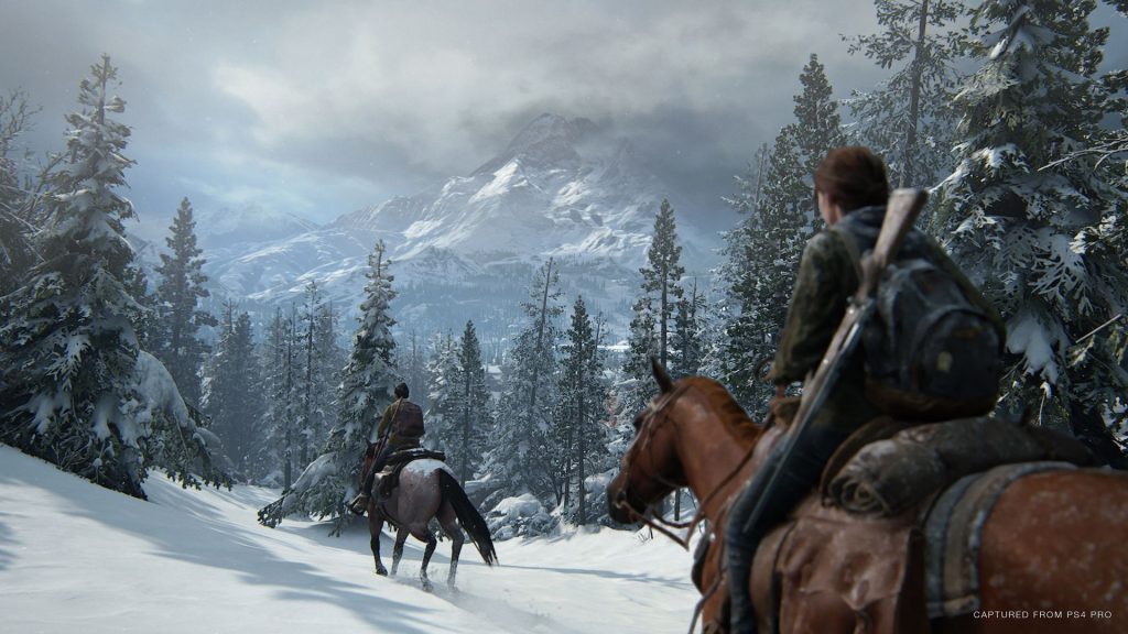 The Last of Us Part 2 screenshot shows two characters riding on horses across a snowy landscape.