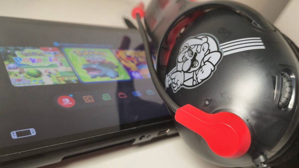 Photo of the Mario Star Airlite Fit headset sitting on top of the Nintendo Switch 2.