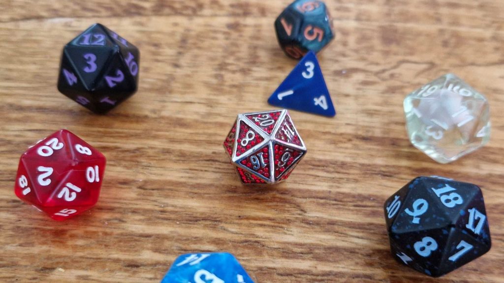 A selection of D&amp;D dice laid out on a wooden table