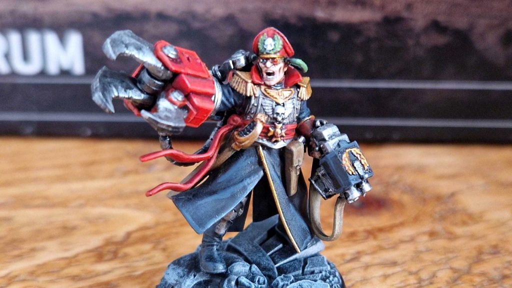 Commisar Yarrick moniature reaching out with a large clawed hand