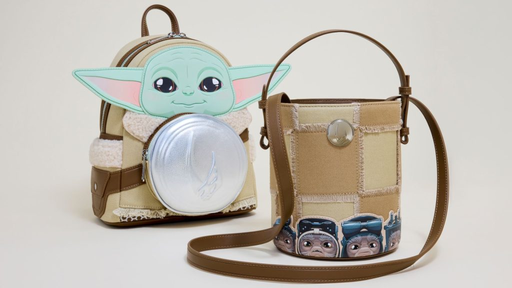 A Grogu mini Loungefly backpack beside a crossbody bag on a gray background
