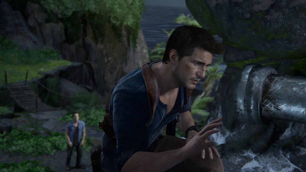 10 years later, Uncharted 4 remains the perfect antidote to overly bleak and serious adventuring Nathan Drake looks at some ruins as Sam watches, in Uncharted 4, from the PS5's Uncharted: Legacy of Thieves Collection