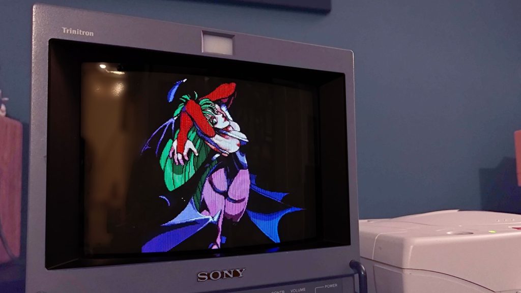 CRTs are the GOAT for retro gaming, but I need monitor makers to consider making OLED alternatives Close up of Sony Trinitron PVM CRT TV with Morrigan from Darkstalkers posing with arms up.
