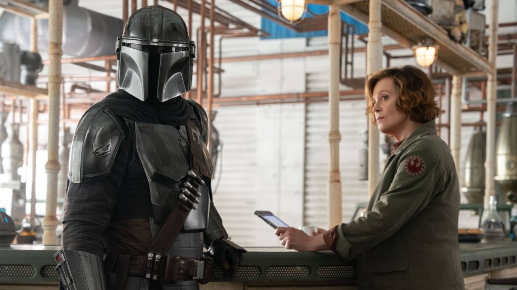 Pedro Pascal as Din Djarin and Sigourney Weaver as Colonel Ward in The Mandalorian and Grogu
