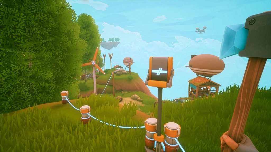 a green field with wires and posts stretching out into the distance