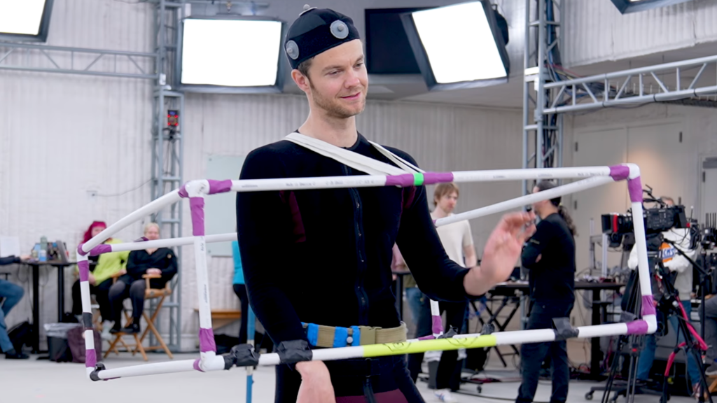 Jack Quaid wears PVC pipes in the shape of a cube around a black bodysuit during God of War motion capture